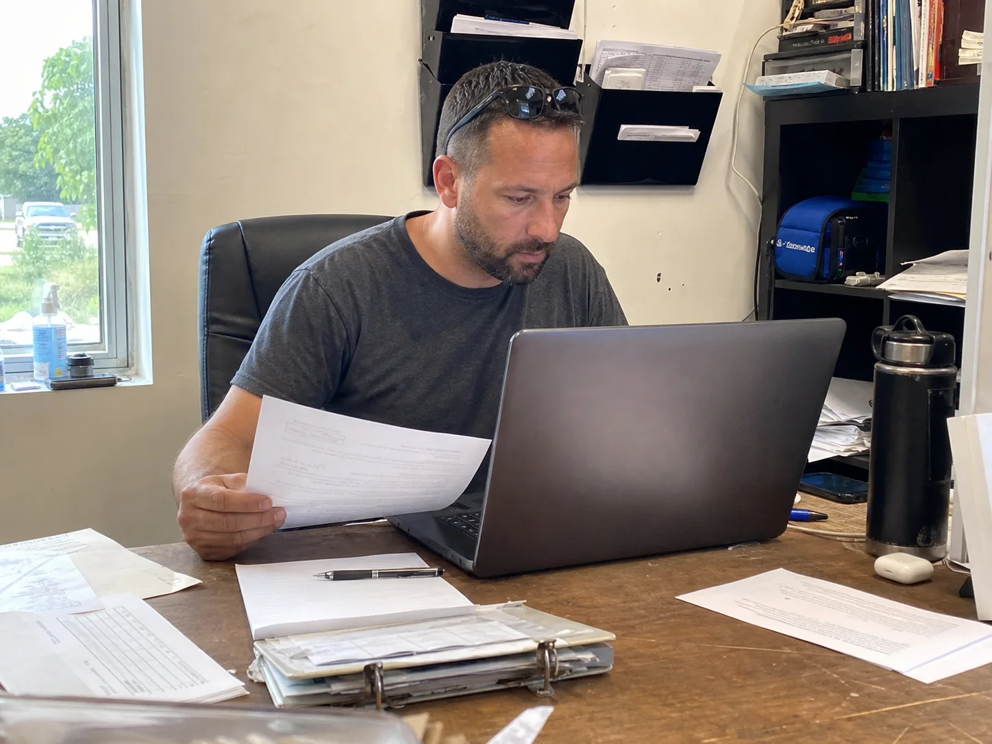 Local service business owner comparing incoming leads with booked job records